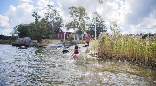 Summer holiday in the archipelago. Kayaking and spending time in a red cottage on an small island. 